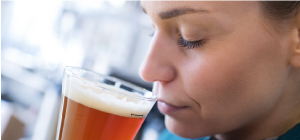 Photo of Woman Smelling Beer