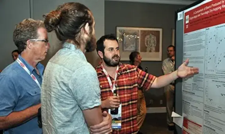 a group of people looking at a poster