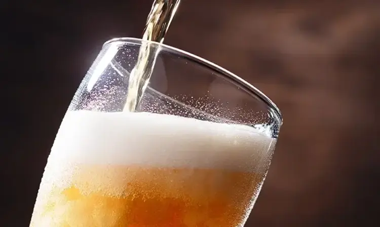 a glass of beer being poured