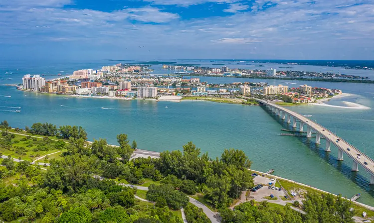 a bridge over water with a city and trees in Clearwater Florida